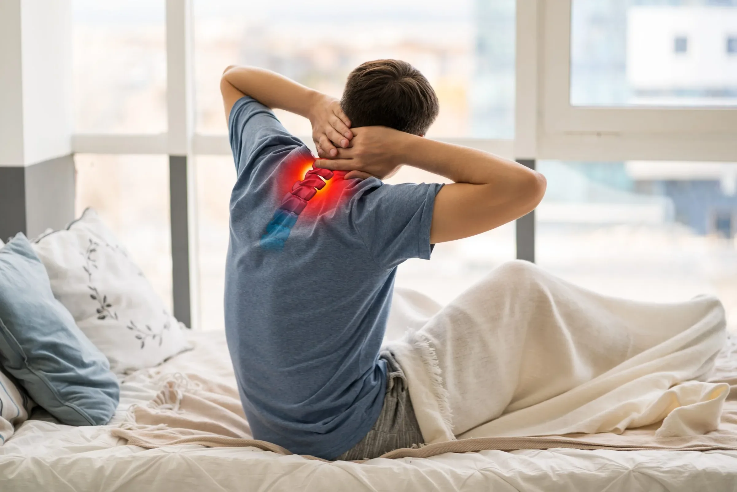 Man sitting on bed holding neck and upper back with red pain indicator overlay showing spinal discomfort.
